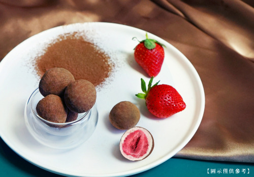 草莓巧克力成品近照，整顆凍乾草莓，使用香醇白巧包覆，外層裹上可可粉。